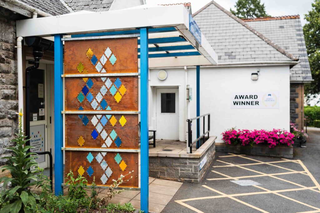 Amy Whittingham's cut glass stain-glassed window installation at the entrance to Ashburton's Health and Wellbeing Centre
