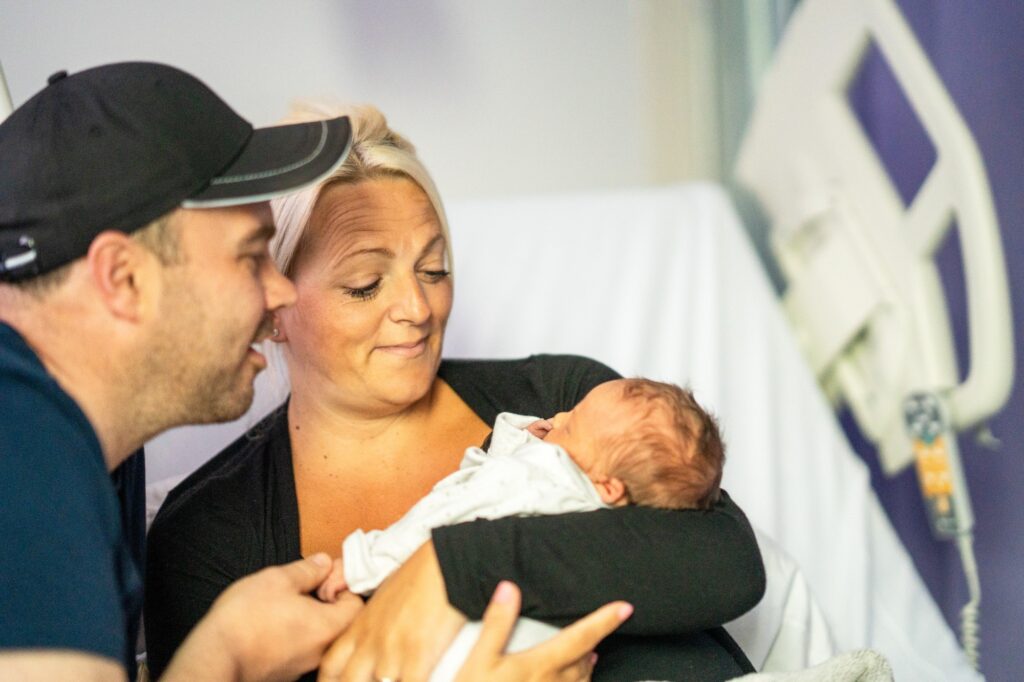 Mother and father holding their baby