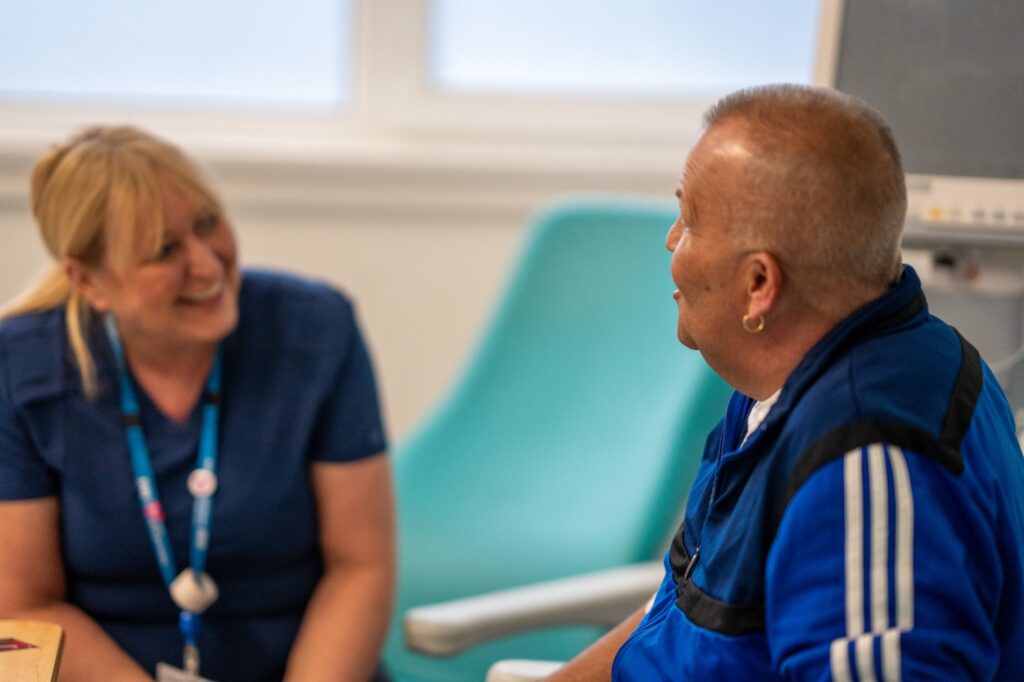 Nurse talking to a patient in a hospital setting