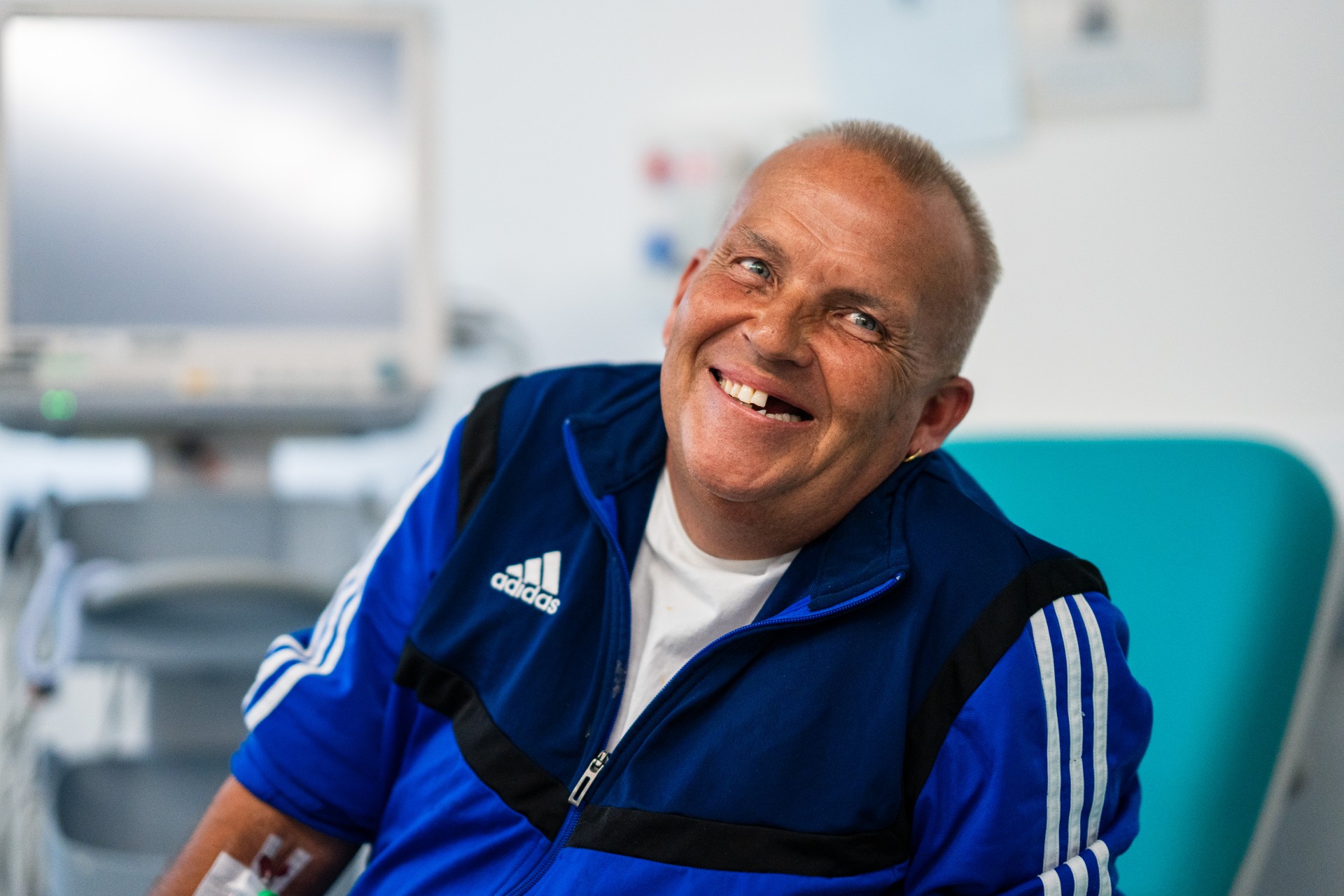 Older person in hospital setting, smiling