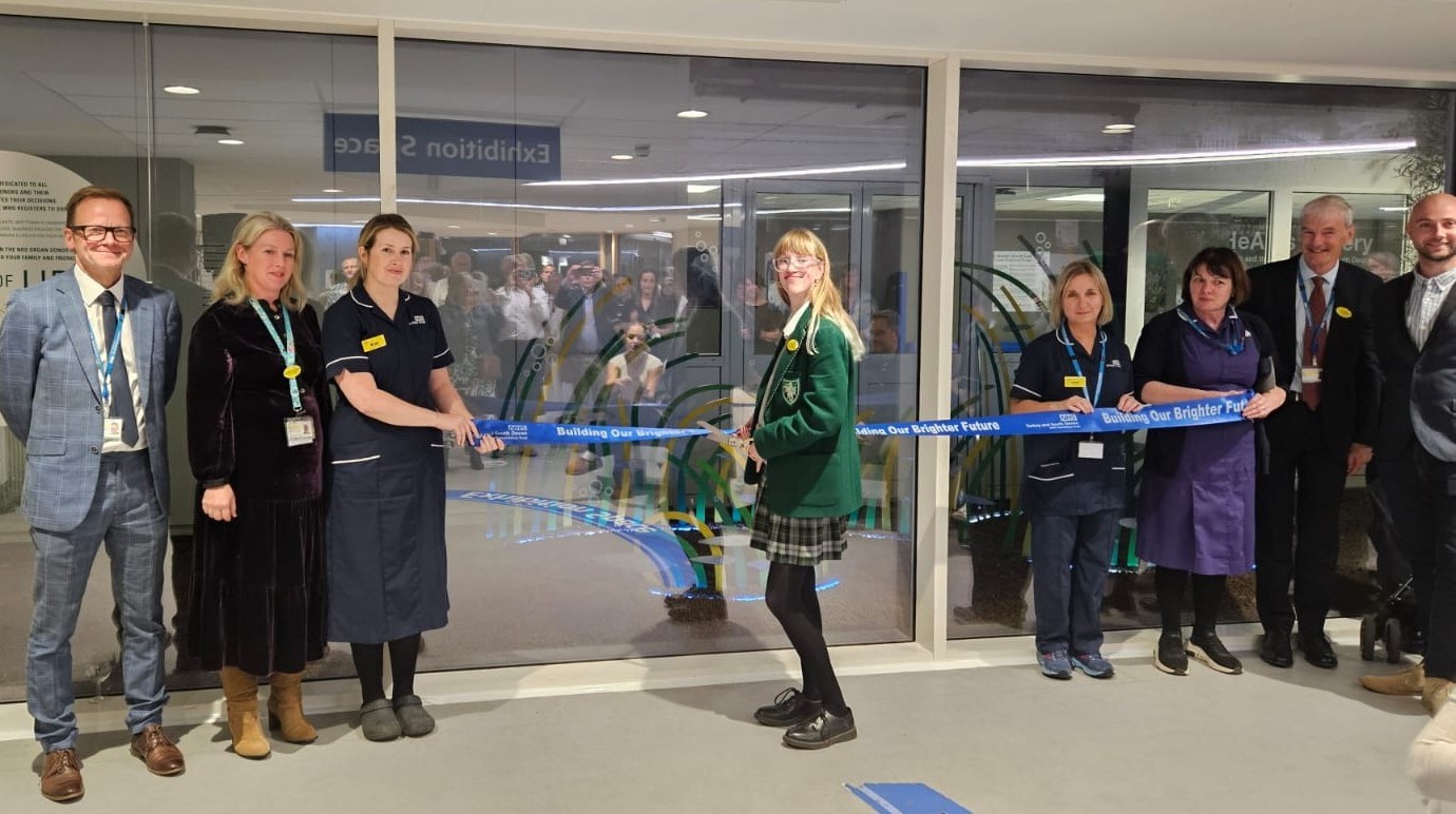 Lottie Bryon-Edmond, cutting the ribbon to unveil our seagrass meadow sculpture, with other attendees.