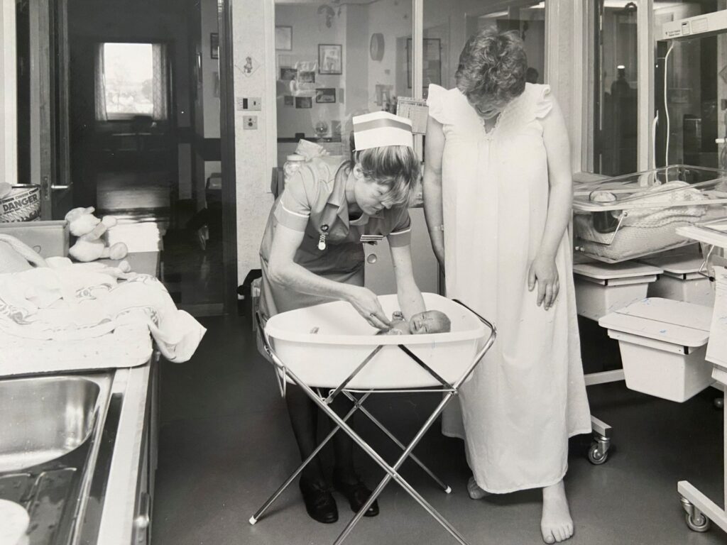 Caoline Aplin in 1985 with a new mother and her baby in Torbay Hospital's Maternity Unit