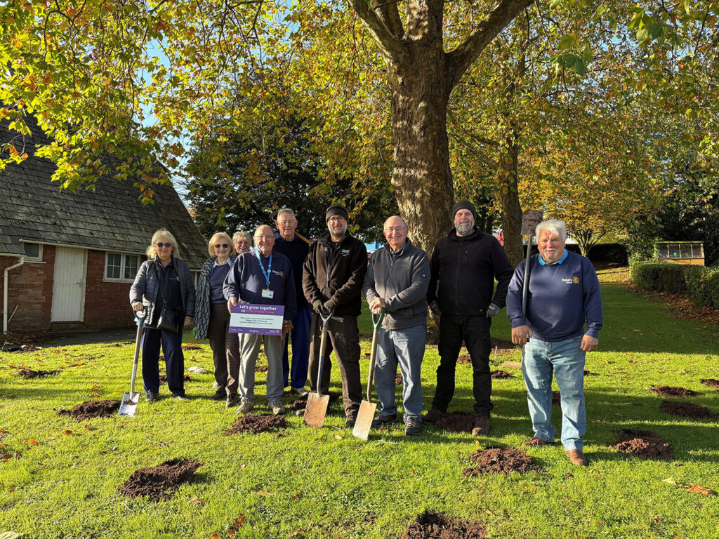 Volunteers from the Rotary Club and hospital staff s by the Lowes Bridge entrance where they have planted 1,000 purple crocus bulbs.