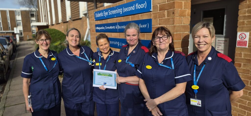 Natalie Herring presenting the members of the Tissue Viability Team their Gold Award