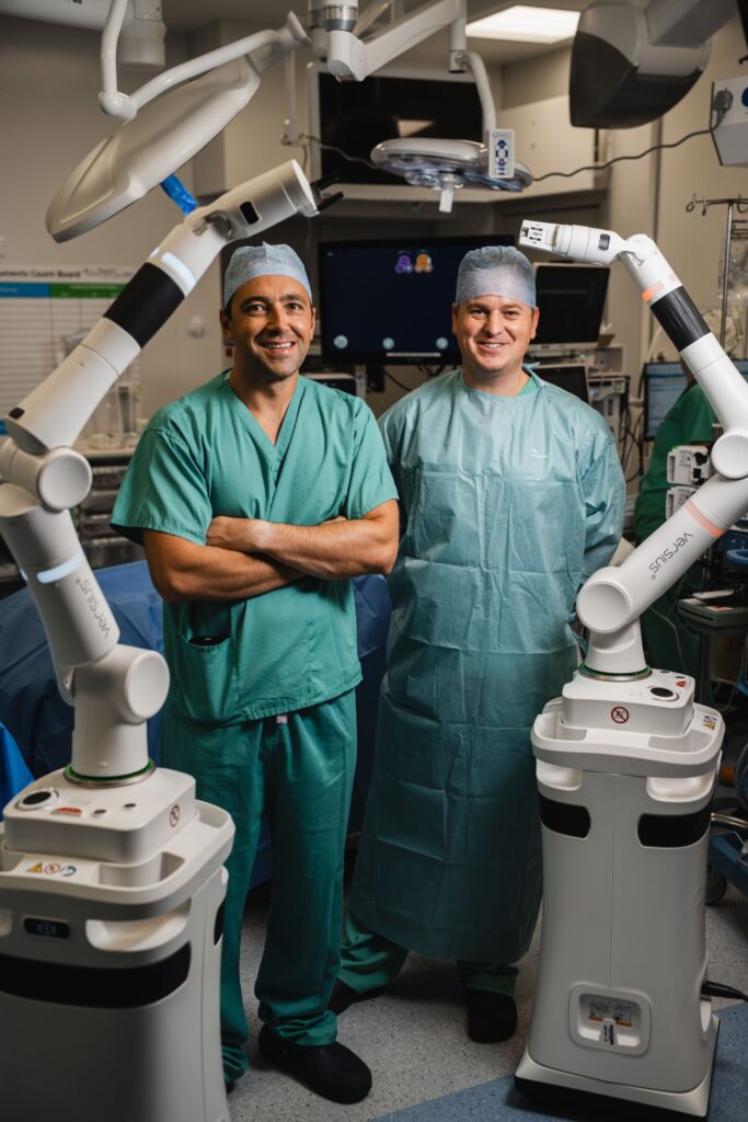 Mr Kostalas and Mr Platt with our new robotic surgeon, Versius Plus