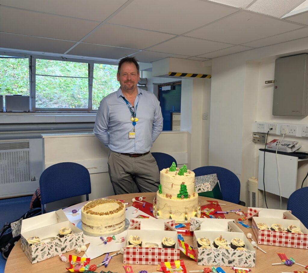 One of our colleagues with a selection of the cakes and bakes for our Christmas Cake Bake