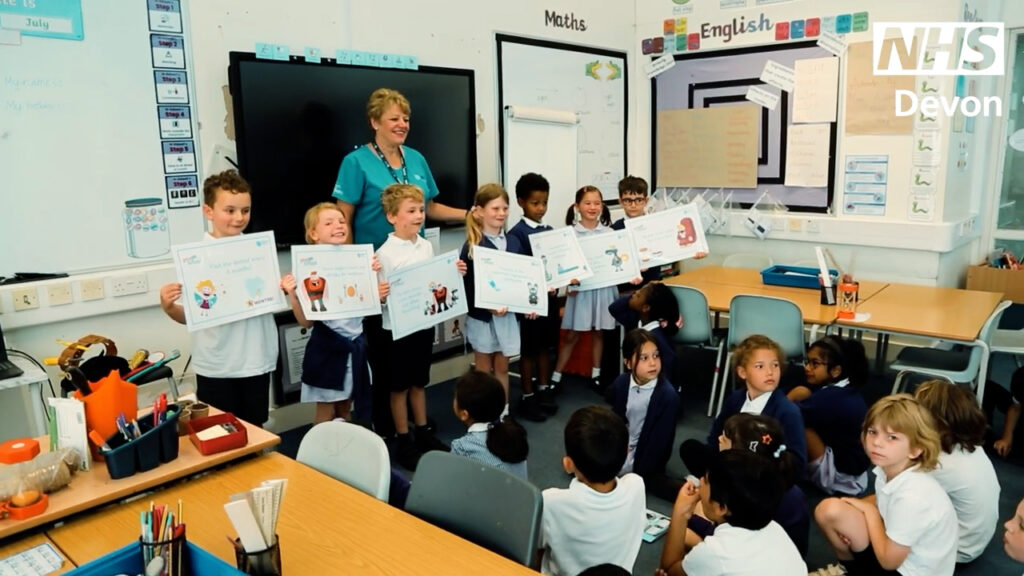 Primary school children attending an Open Wide and Step Inside (OWSI) session in class