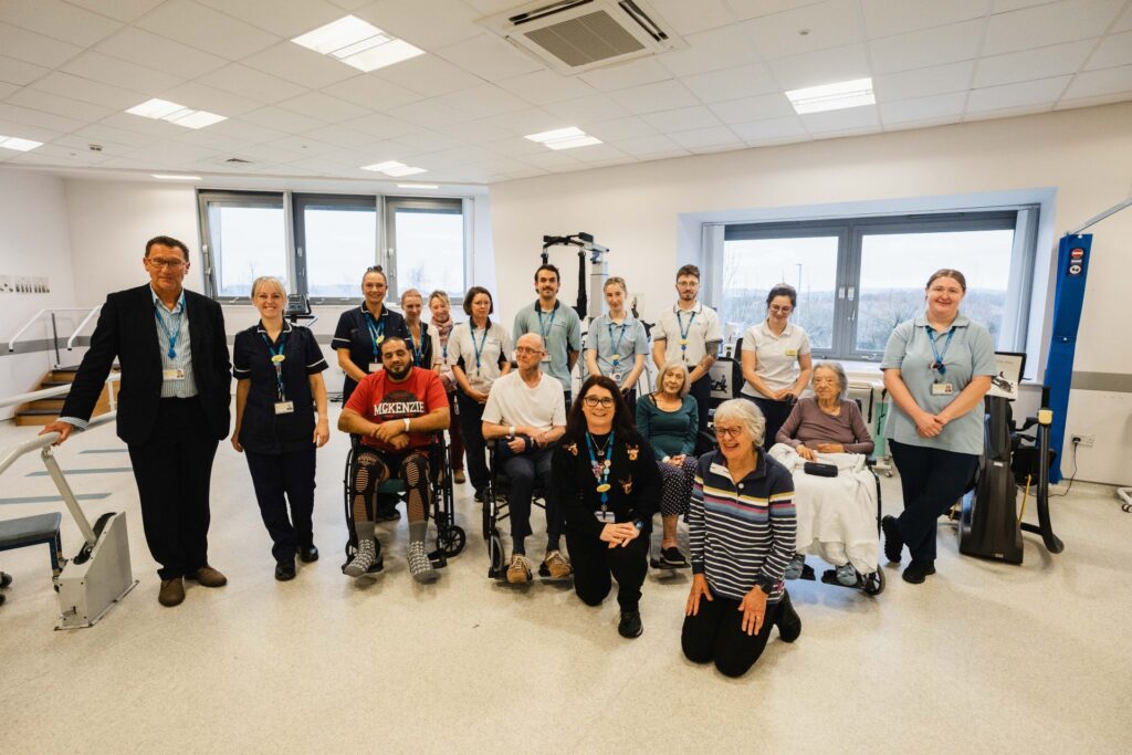 Community Neuro Rehabilitation colleagues, Martin Beaman, Vice Chair, Newton Abbot Hospital’s League of Friends, and patients in the hospital's gym room
