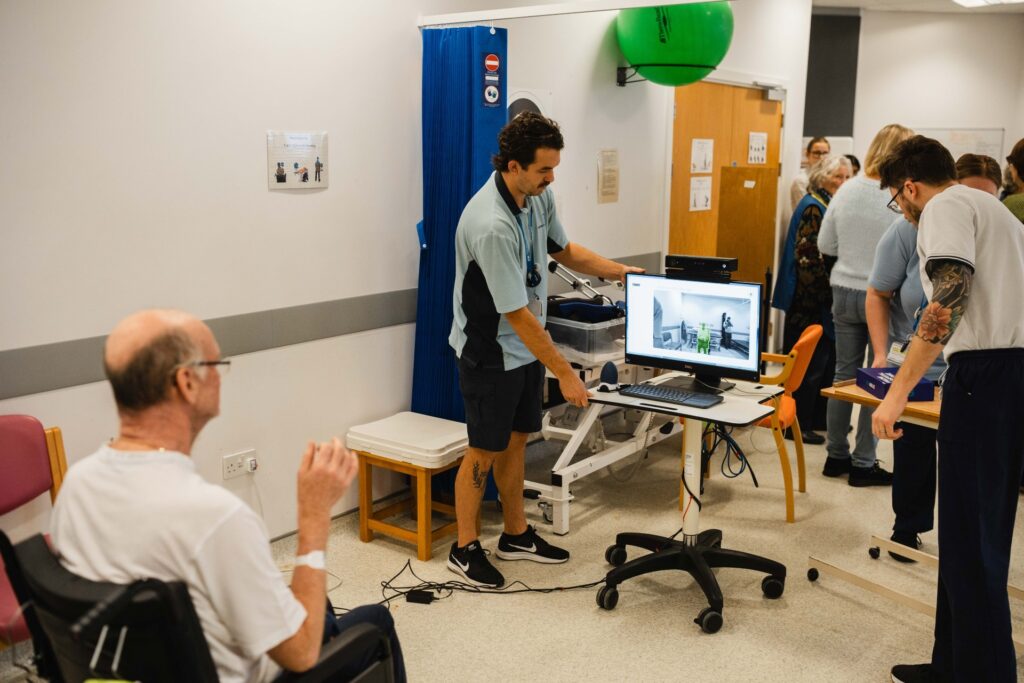 Patient with physiotherapists in Newton Abbot Community Hospital's rehab gym