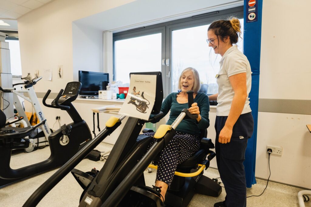 Patient with physiotherapist in Newton Abbot Community Hospital's rehab gym