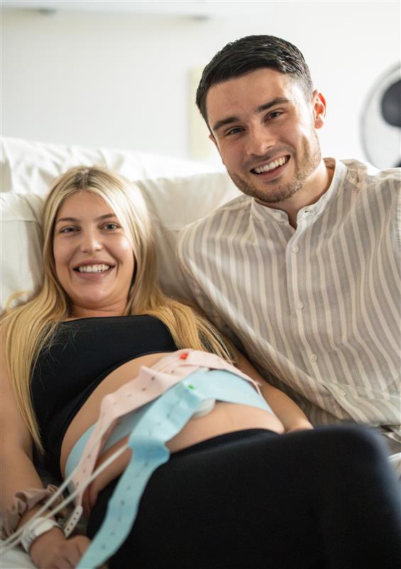 Pregnant woman with her partner in a hospital setting