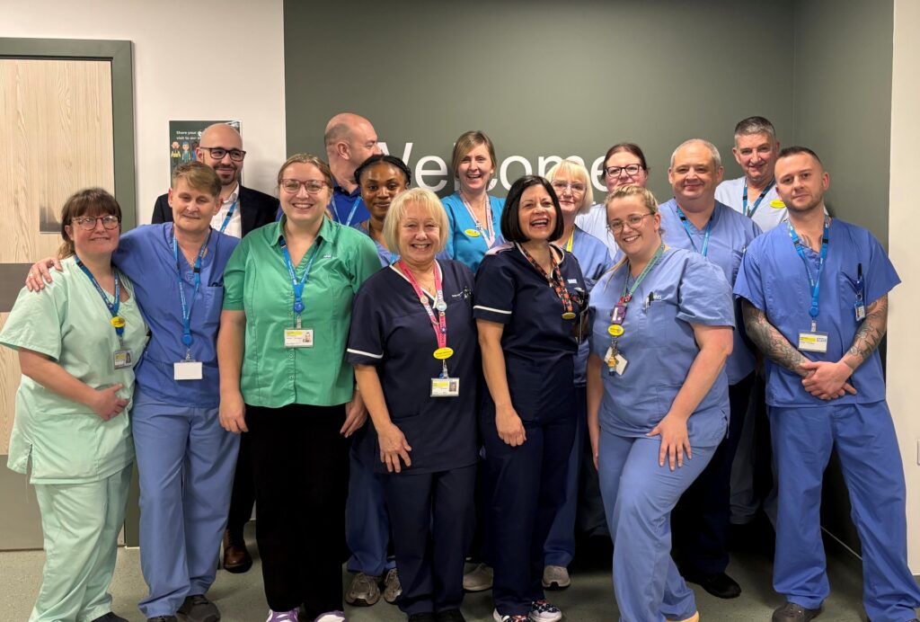 Members of the endoscopy team standing in front of a welcome sign
