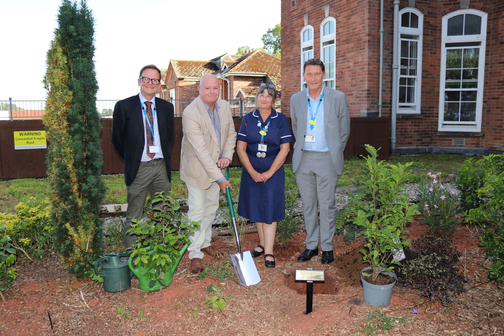 Planting of a commemorative magnolia tree in Torbay Hospital's Rose Garden. Part of marking 100 years since the foundation stone was laid at Torbay Hospital
