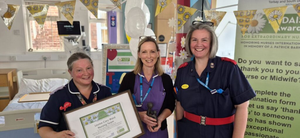 A group of colleagues at a Daisy Awards presentation