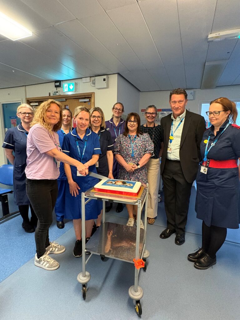 Maternity triage team and colleagues cutting the cake at the opening celebration
