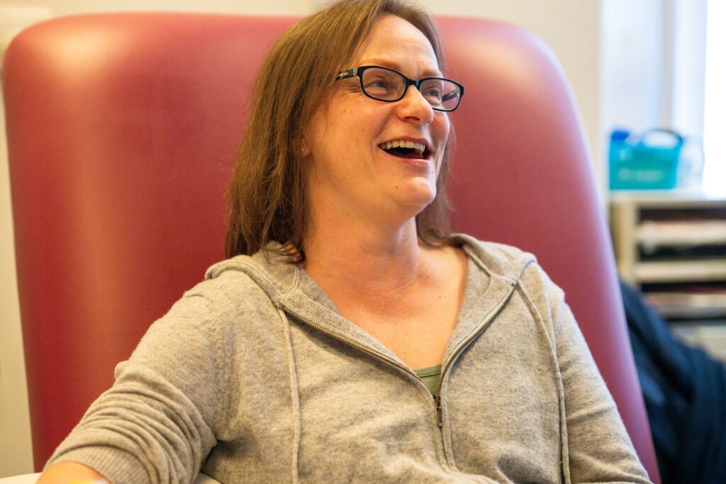 Smiling woman sat in a hospital chair