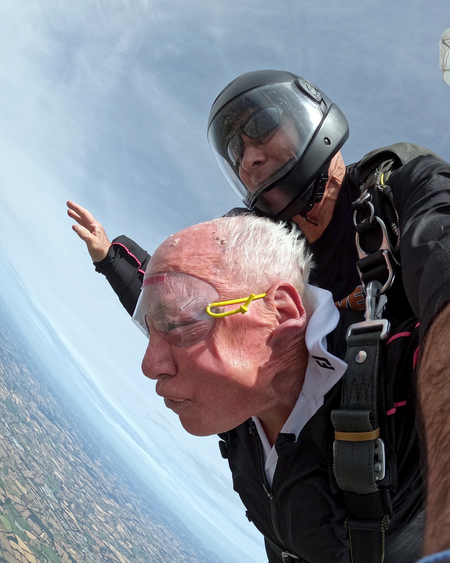 John Payne with his skydiving instructor as free fall above Devon.