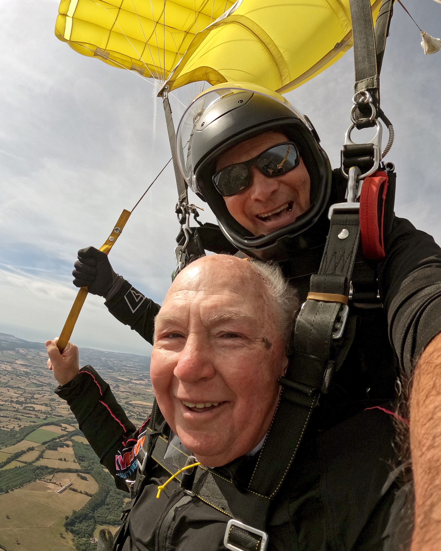 John Payne with his skydiving instructor as they glide back down.