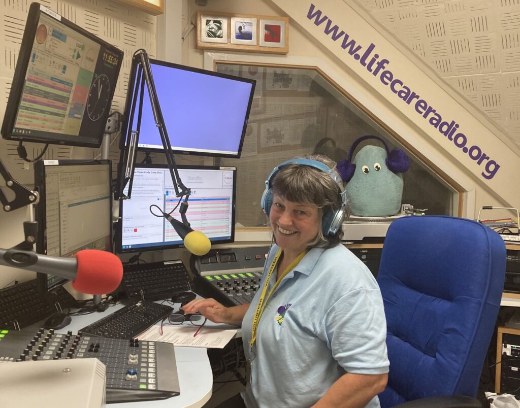 One of the Life Care Radio presenters in the station's booth