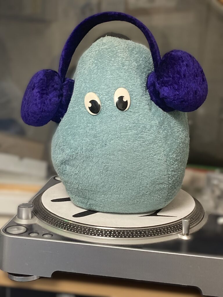 Life Care Radio's mascot Elsie, egg-shaped and wearing headphones – representing new life.