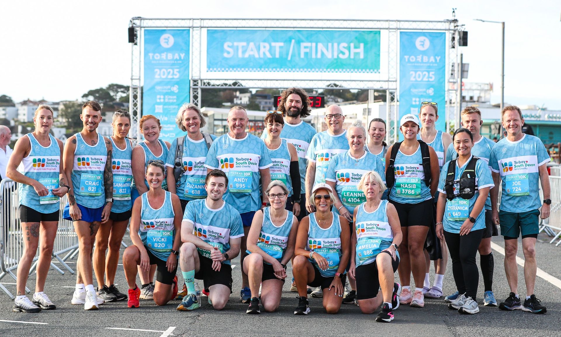 Some of our NHS Torbay Blue Wave runners at the start line for the Torbay Marathon and 10K 2025