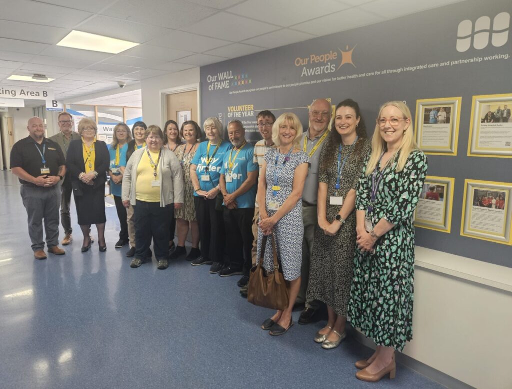 Colleagues and volunteers at the unveiling of our Volunteer Wall of Fame at Torbay Hospital