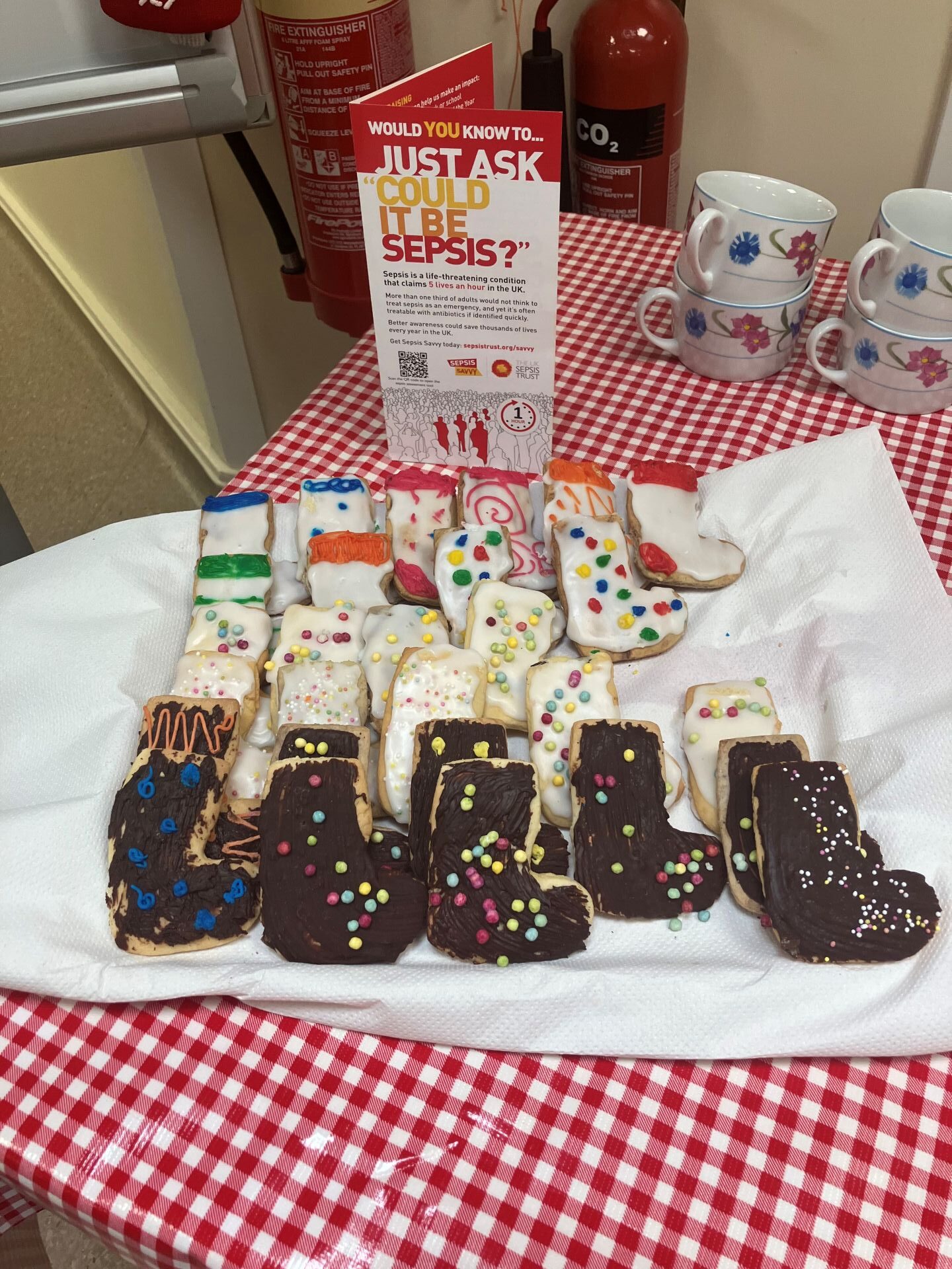 Tea and biscuits in the shape of socks with colourful decorations
