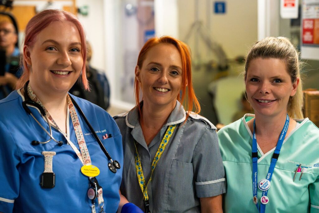 Three student nurses smiling