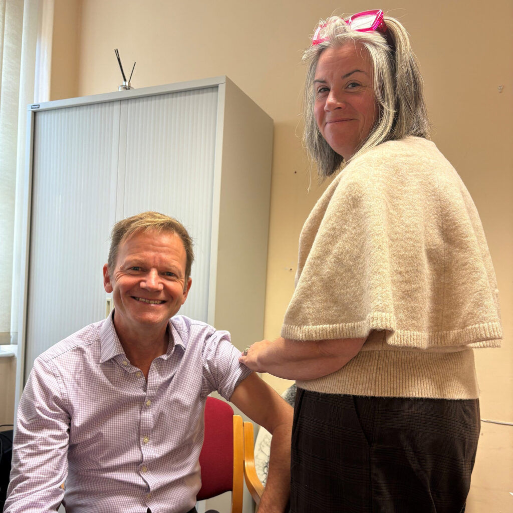 Joe Teape receiving his flu vaccination from Natalie Herring
