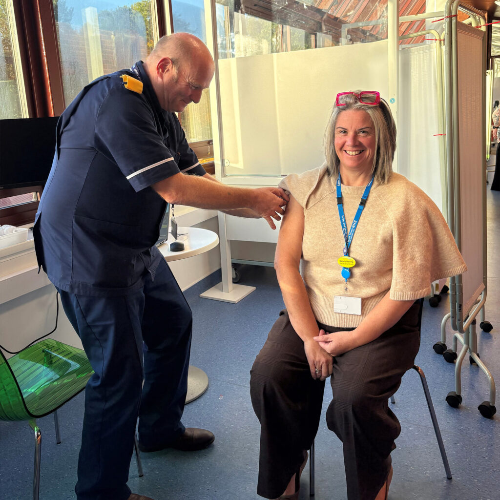 Natalie Herring receiving her flu vaccination from Steve Carr