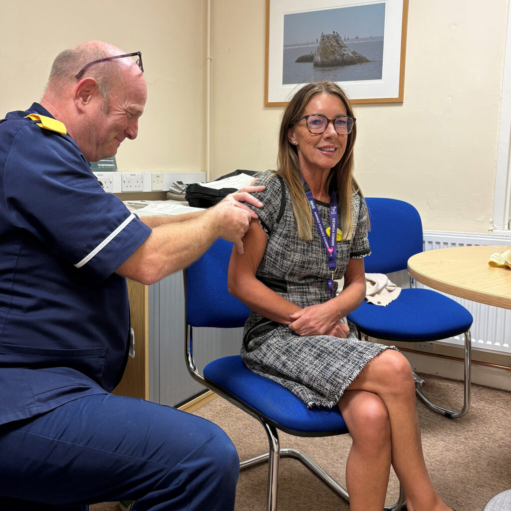 Nicola McMinn receiving her flu vaccination from Steve Carr